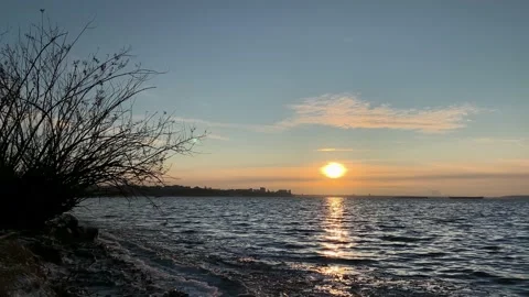 Dramatic light in the sea against the backdrop of city. Beautiful background Stock Footage 143379868