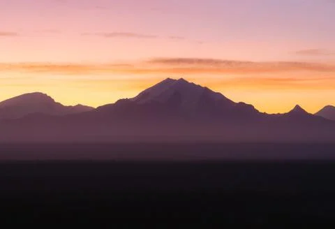 Dramatic light with silhouette of mountains during sunrise Stock Photos