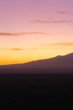 Dramatic light with silhouette of mountains during sunrise Stock Photos