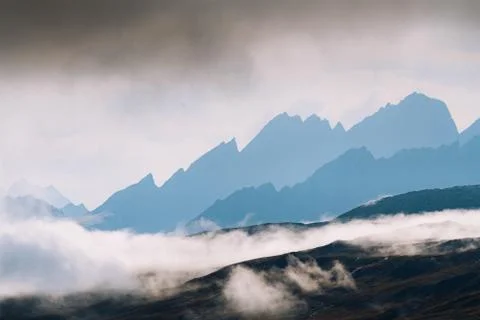 Dramatic light with silhouette of mountains Stock Photos