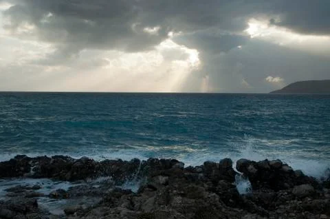 Dramatic Light with Sun Rays and Heavy Clouds above Mediterranean Sea Stock Photos