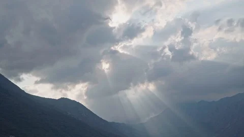 Dramatic light through clouds at sunset over mountains Stock Footage 121991131