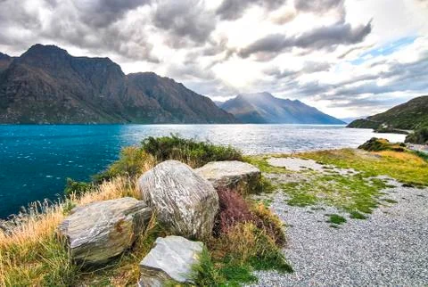 Dramatic lighting and tall mountains in New Zealand Stock Photos
