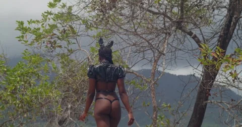 Dramatic lighting on a dark-skinned girl in a bunny costume at a tropical fort Stock Footage 335120991