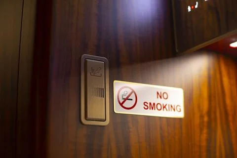 Dramatic lighting enhances safety message in aircraft restroom scene Stock Photos