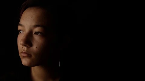 Dramatic lighting on teen's face Stock Footage 121242714