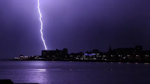 Dramatic Lightning Flash Over Buildings in Montevideo Uruguay - Zoom Out Stock Footage 100390433