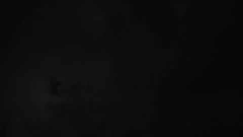 Dramatic lightning illuminates the night sky in a powerful thunderstorm Stock Footage 316477368