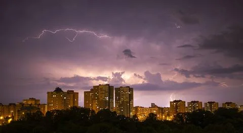 Dramatic lightning storm with multiple cloud-to-cloud strikes illuminating Stock Photos