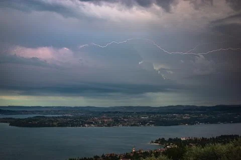 Dramatic lightning storm over a small town near Garda Lake, Italy Stockfoto's