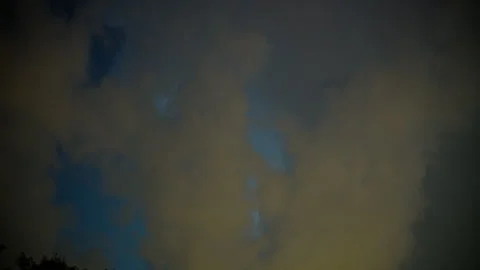 Dramatic lightning strike illuminating dark storm clouds during a powerful Видео 346019235