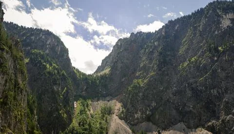 Dramatic Limestone Mountain Cliffs Rising Above Forested Alpine Valley Bene.. Stock-Fotos