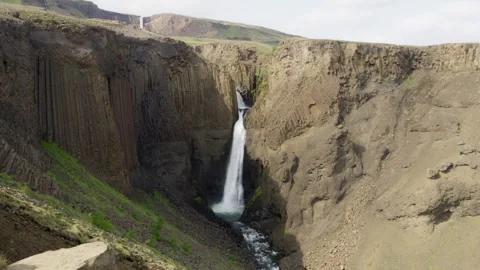 Dramatic Litlanesfoss waterfall cascading through basalt canyon on Iceland 스톡 동영상 348234381