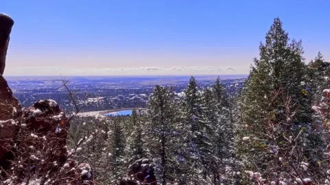 Dramatic long shot of city from a snowy mountain road Stock Footage 219894600