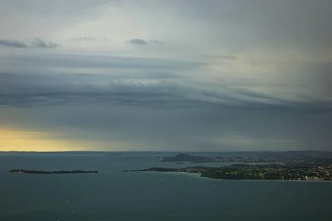 Dramatic looking storm clouds with corkscrew appearance over Lake Garda, Italy. Stock Photos