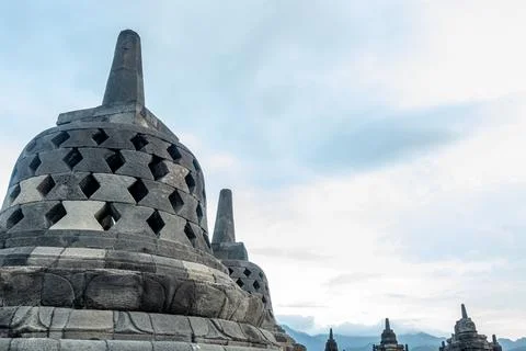 Dramatic Low Angle Borobudur Temple Structure Against Cloudy Sky Landscape Stock Photos