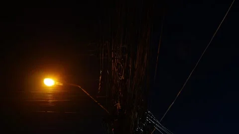 Dramatic low angle night view of tangled electric power cable Stock Footage 336593516