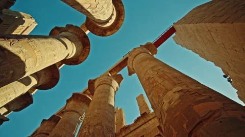 Dramatic low angle perspective of monumental stone columns with hieroglyph Stock Footage 324866673