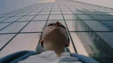 Dramatic Low-Angle Portrait of Woman Beneath Skyscraper Stock Footage 345883272