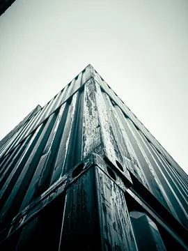 A dramatic low-angle shot captures the rugged texture and sharp lines of a sh Stock Photos