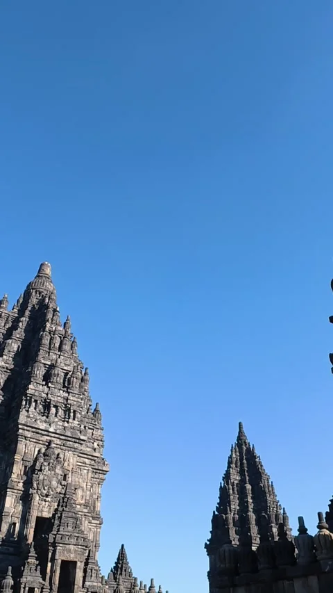 Dramatic low-angle view captures dark Prambanan Temple spires rising sharpl.. Video stock 341543167