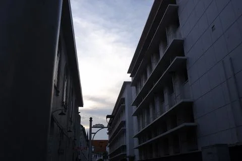Dramatic Low Angle View of Colonial and Modern Buildings Against Cloudy Sky Stock Photos