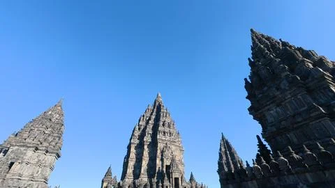 Dramatic low-angle view of multiple Prambanan Temple spires rising sharply .. Stock Photos