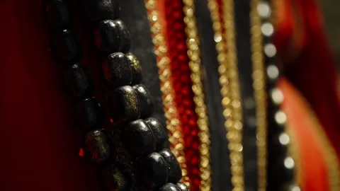 Dramatic macro close-up of layered beaded necklaces with glossy black beads Stock Footage 327531064
