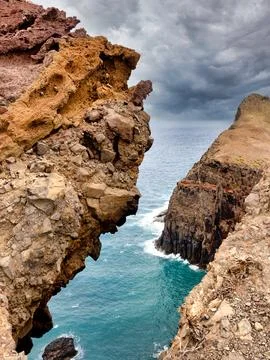 Dramatic Madeira Cliff Arch View - Intense vertical shot of a rugged volcan.. Stock Photos