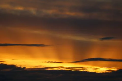 Dramatic Malaga sunset with powerful sunbeams shining through the clouds Stock Photos