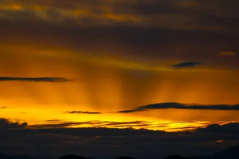 Dramatic Malaga sunset with powerful sunbeams shining through the clouds Stock Photos