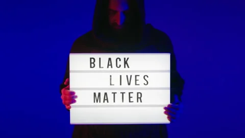 Dramatic man in hood hold black lives matter sign Video stock 132192033