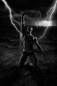 Dramatic man with naked torso kneeling on dry ground in stormy weather Stock Photos