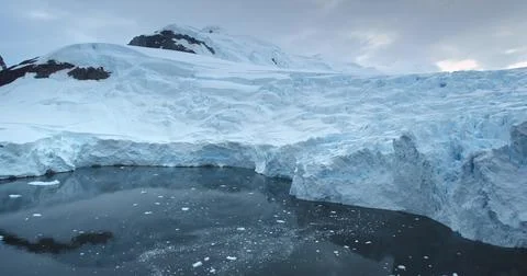 Dramatic massive blue glacier towering Antarctica Stock Photos