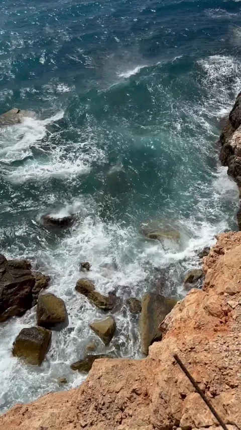 Dramatic Mediterranean coast with foamy waves on rocky shore. Stock Footage 315160332