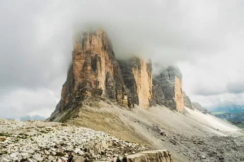 Dramatic misty Tre Cime di Lavaredo area. Dynamic clouds after rain move ov.. Stock Photos