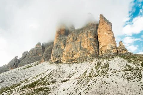 Dramatic misty Tre Cime di Lavaredo area. Dynamic clouds after rain move ov.. Stock Photos