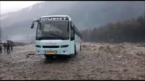 Dramatic moment bus is swept away by floods in northern India Stock Footage 106315306