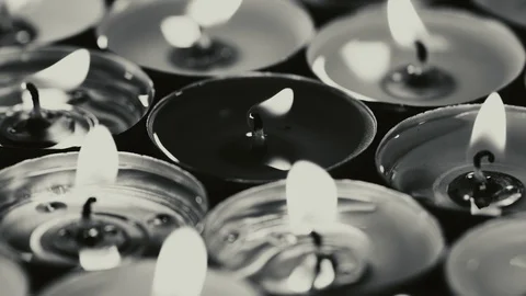 Dramatic monochrome of candles burning in the dark in UHD Stockbeeldmateriaal 95708485