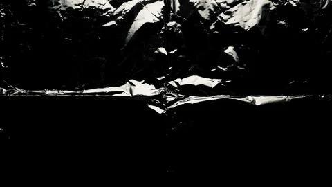 Dramatic monochrome crumpled foil abstract texture intense highlights deep .. Stock Photos