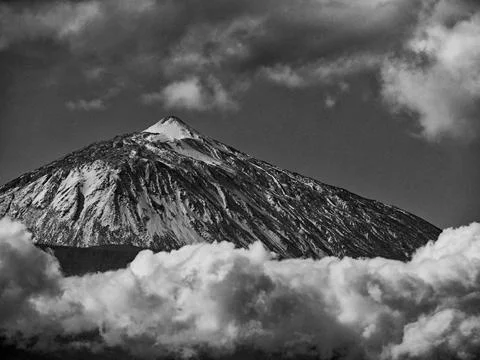 Dramatic monochrome of snowcapped Mount Teide, Tenerife and clouds Stock Photos