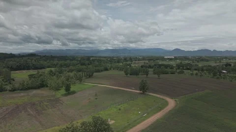 Dramatic Monsoon Clouds Rolling Over Mountain Range and Tropical Farmland, .. Stock Footage 337011242