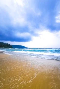 Dramatic monsoon rain clouds turquoise surf Kata Noi Beach Thailand Stock Photos