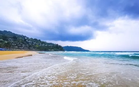 Dramatic monsoon rain clouds turquoise surf Kata Noi Beach Thailand Stock Photos
