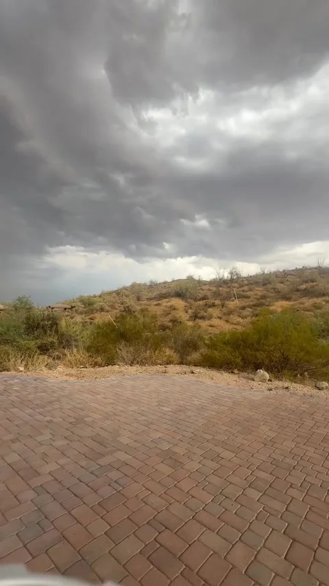 Dramatic Monsoon Storm Clouds and Sunbeams Over Desert Home Driveway Stock Footage 339799336
