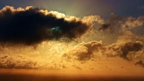 Dramatic, moody sky cloudscape with sun behind dark and golden clouds Stock Footage 321128958