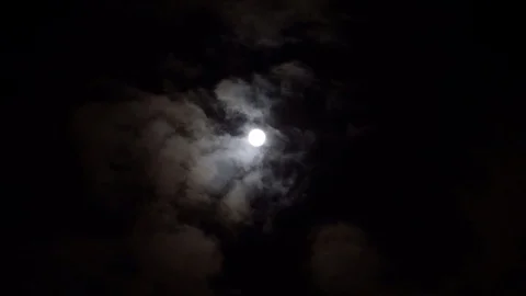 Dramatic moon on night sky. Bright moon between volume clouds. Esoteric time. Stock Footage 108013647
