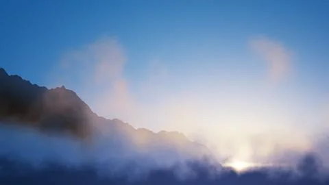 Dramatic Morning Mist over Mountain Peaks with Sunrise Light and Blue Sky Stock Illustration