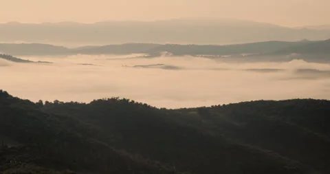 Dramatic mountain and hill tops with fog in the valley Stock Footage 242933112