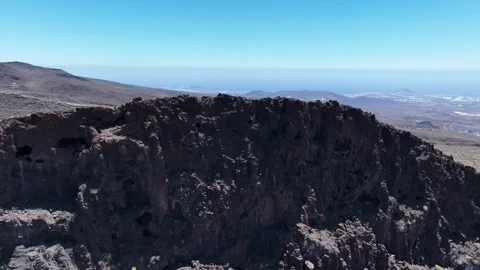 Dramatic Mountain with Caves and Coastal Backdrop – Temisas, Gran Canaria Stock Footage 310146389